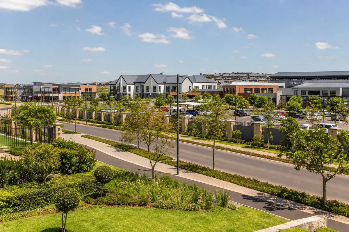 Modern residential boulevard with schools and retail buildings in Hazeldean, within HoneySucker's Pretoria East septic service coverage